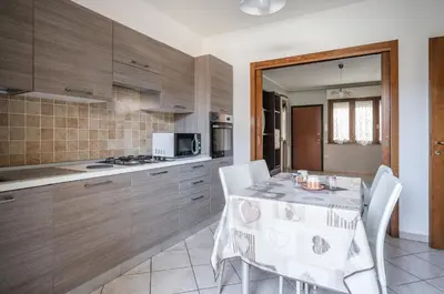 Cucina o angolo cottura di GuestHost - Sestu Lovely Apt W Balcony near Spiaggia Poetto!