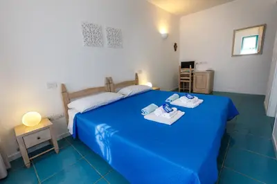 Letto o letti in una camera di Villa Tre Mari