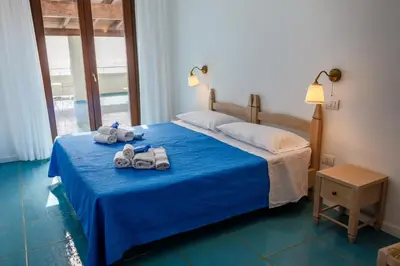 Letto o letti in una camera di Villa Tre Mari