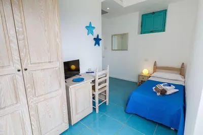Letto o letti in una camera di Villa Tre Mari