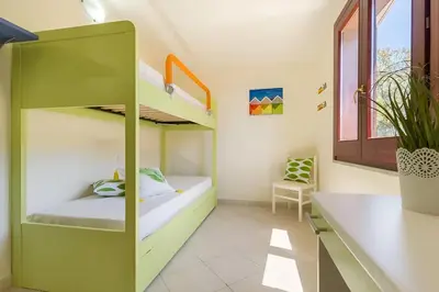 Letto o letti in una camera di Villa Regina - Doppia villetta vista mare con giardino e BBQ