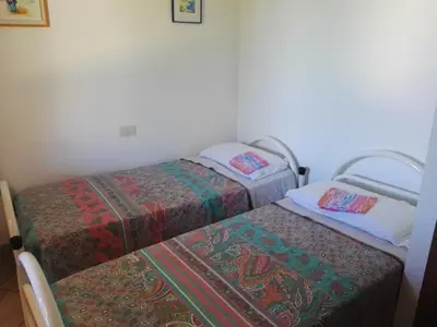 Letto o letti in una camera di Casa Pepe, Confortevole villetta con giardino a 2 min dal mare