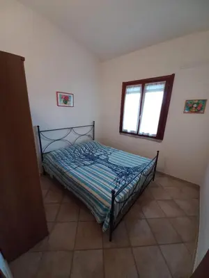 Letto o letti in una camera di Casa Pepe, Confortevole villetta con giardino a 2 min dal mare