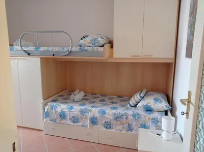 Letto o letti in una camera di La casa di Paola a Calasetta - IUN R2452