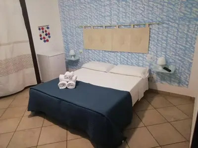 Letto o letti in una camera di B&B Acquamarina Villasimius