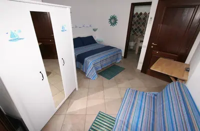 Letto o letti in una camera di B&B Acquamarina Villasimius