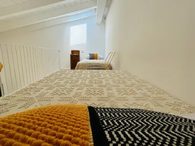 Letto o letti in una camera di Palazzo Ma.Ri.Lu.