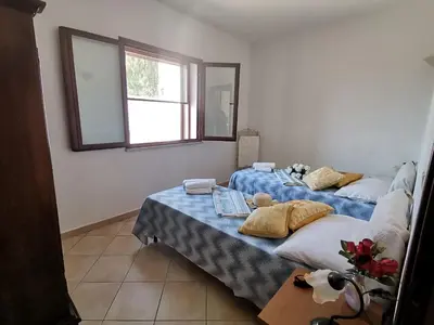 Letto o letti in una camera di Piccolo Residence vicino alla spiaggia con bellissima vista mare