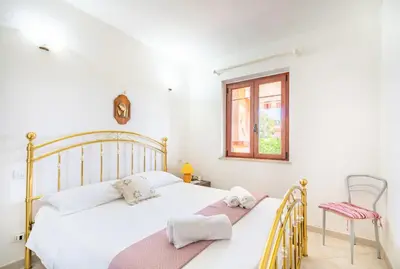 Letto o letti in una camera di Costa Rei - spiaggia 3' a piedi - Giardino BBQ