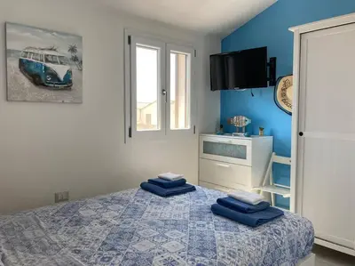 Letto o letti in una camera di Flamingo's House in Sant'Antioco, Sardinia