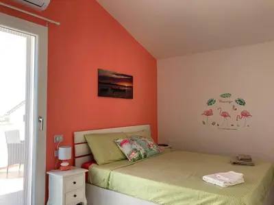 Letto o letti in una camera di Flamingo's House in Sant'Antioco, Sardinia