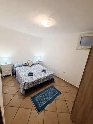 Letto o letti in una camera di Casa vacanze Campulongu a 150 mt dal mare, Villa Carolina