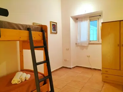 Letto o letti in una camera di Casa Marta