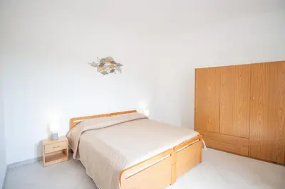 Letto o letti in una camera di SA DOMU DE S'ORTU