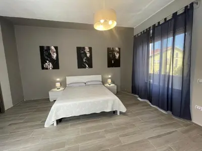 Letto o letti in una camera di APPARTAMENTO ELEGANTE CARBONIA