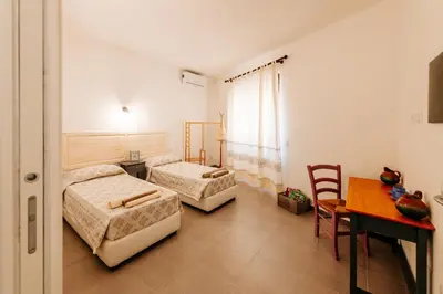 Letto o letti in una camera di Domo Mediterranea Affittacamere-Guest House