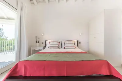 Letto o letti in una camera di Villa Mandorlo a soli 500 mt dal mare con piscina privata e vista mare