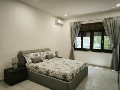 Letto o letti in una camera di Bidda Mores Appartamenti- I Velieri