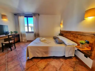 Letto o letti in una camera di Domos de Ammentos