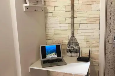 TV o dispositivi per l'intrattenimento presso Oasi del Relax - Seaside Peaceful Panoramic Terrace in ITALY - new Sardinia apartment 50 mt beach&sea full comfort air conditioning-WiFi-Parking-Privacy