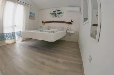 Letto o letti in una camera di Oasi del Relax - Seaside Peaceful Panoramic Terrace in ITALY - new Sardinia apartment 50 mt beach&sea full comfort air conditioning-WiFi-Parking-Privacy