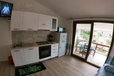 Cucina o angolo cottura di Oasi del Relax - Seaside Peaceful Panoramic Terrace in ITALY - new Sardinia apartment 50 mt beach&sea full comfort air conditioning-WiFi-Parking-Privacy
