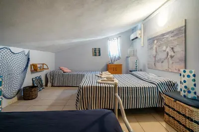 Letto o letti in una camera di GuestHost - Torre di Calasetta Cozy Apartment
