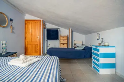 Letto o letti in una camera di GuestHost - Torre di Calasetta Cozy Apartment