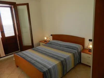 Letto o letti in una camera di Le Residenze di Porto Corallo