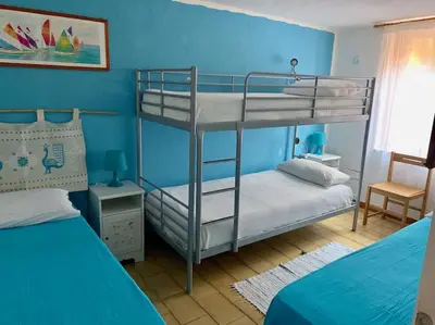 Letto o letti in una camera di Villa Cala Sinzias