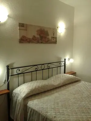 Letto o letti in una camera di Costa Rei casa vacanze Gi.&Gi.