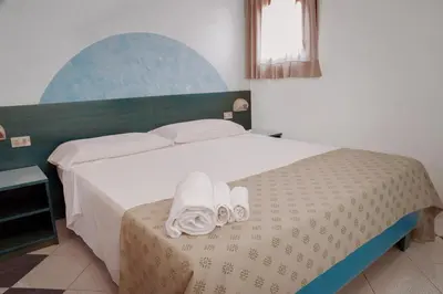 Letto o letti in una camera di Residence Verde Mare Official Site