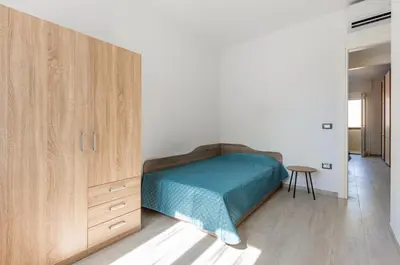 Letto o letti in una camera di GuestHost - Quartu Sant'Elena Roomy Flat with Private Parking!
