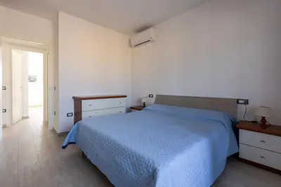 Letto o letti in una camera di GuestHost - Quartu Sant'Elena Roomy Flat with Private Parking!