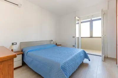 Letto o letti in una camera di GuestHost - Quartu Sant'Elena Roomy Flat with Private Parking!