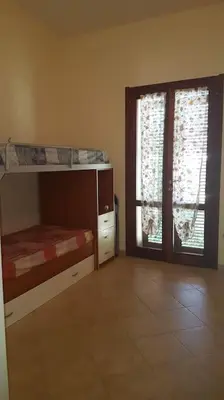 Letto o letti in una camera di Vittorio House Villetta indipendente con giardino a Villasimius