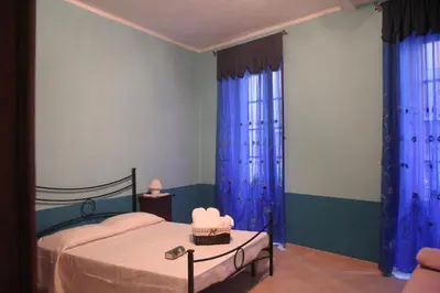 Letto o letti in una camera di B&B Su Maimoni
