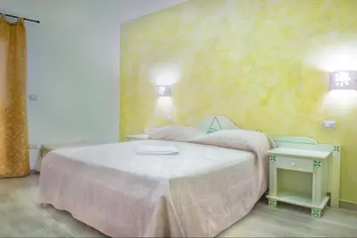 Letto o letti in una camera di Domo La Vela - Affittacamere - Living Sant'Antioco