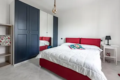 Letto o letti in una camera di GuestHost - Cagliari Flat near the Station with Balcony!