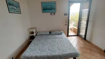 Letto o letti in una camera di Villetta Mari Pintau
