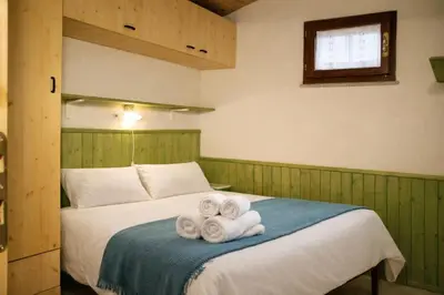 Letto o letti in una camera di la casetta dei pescatori PORTO PINO