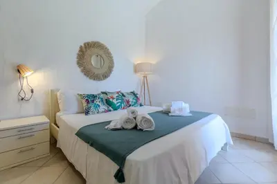 Letto o letti in una camera di Porto Pino, Garden and Pool SouthSardiniaHolidays