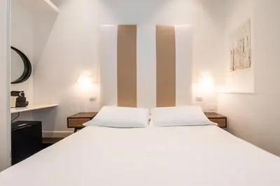 Letto o letti in una camera di PLEY Cagliari Boutique Rooms