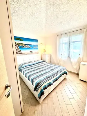 Letto o letti in una camera di Suites Dreams Sardegna Vista Mare CostaRei