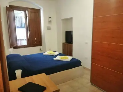 Letto o letti in una camera di Piccolo nido nel cuore di Cagliari