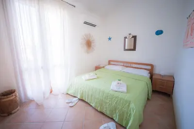 Letto o letti in una camera di Villetta Corallina (service fee waived)