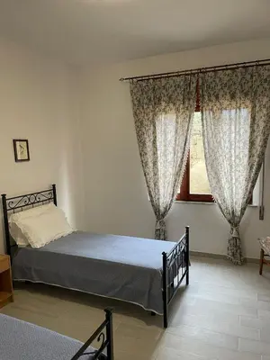 Letto o letti in una camera di Casa Beatrice