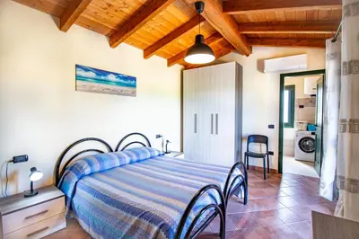 Letto o letti in una camera di Chelu & Mare con terrazza e vista panoramica