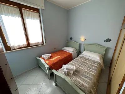 Letto o letti in una camera di Appartamento a 50 metri dal mare a Maladroxia C36
