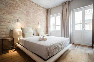 Letto o letti in una camera di Trinità UrbanNest - Cuore di Cagliari